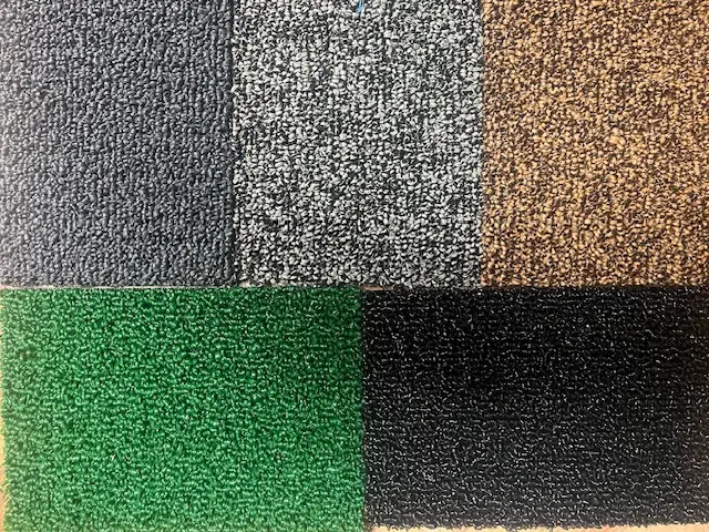 Four grass loop carpet color samples in gray, brown, green, and black.