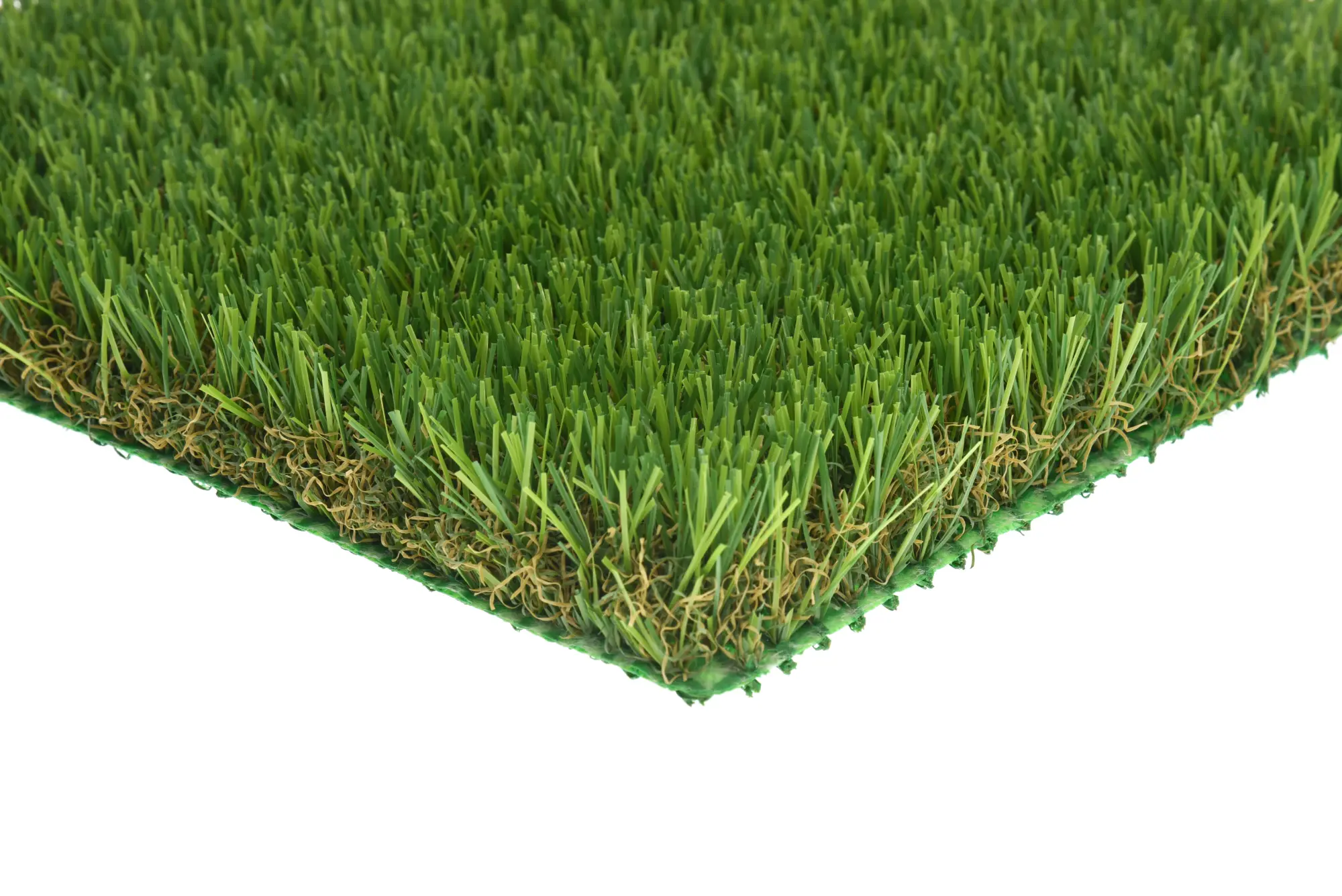 Close up of thick green artificial grass showing layered brown thatch