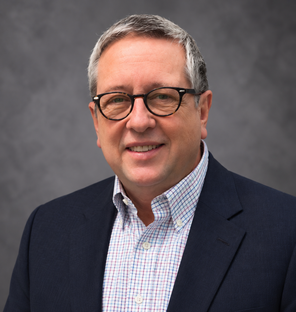 Friendly business portrait of gray haired man wearing glasses and blazer